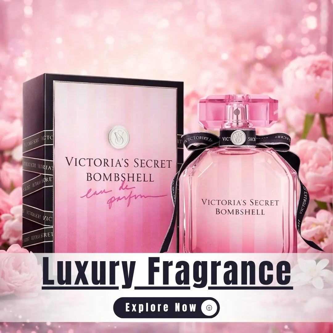 Victoria's Secret Bombshell perfume bottle and packaging with pink flowers in the background